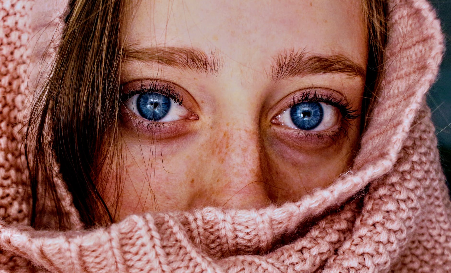 woman with blue eyes wrapped in a pink cloth
