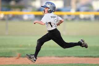 baseball player in gray and black uniform running