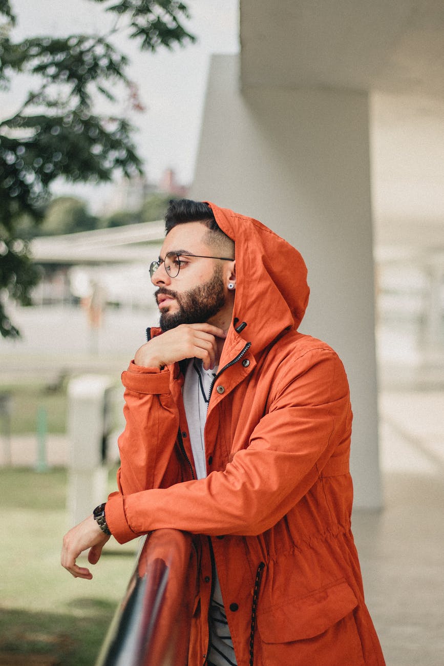 man wearing orange hooded jacket
