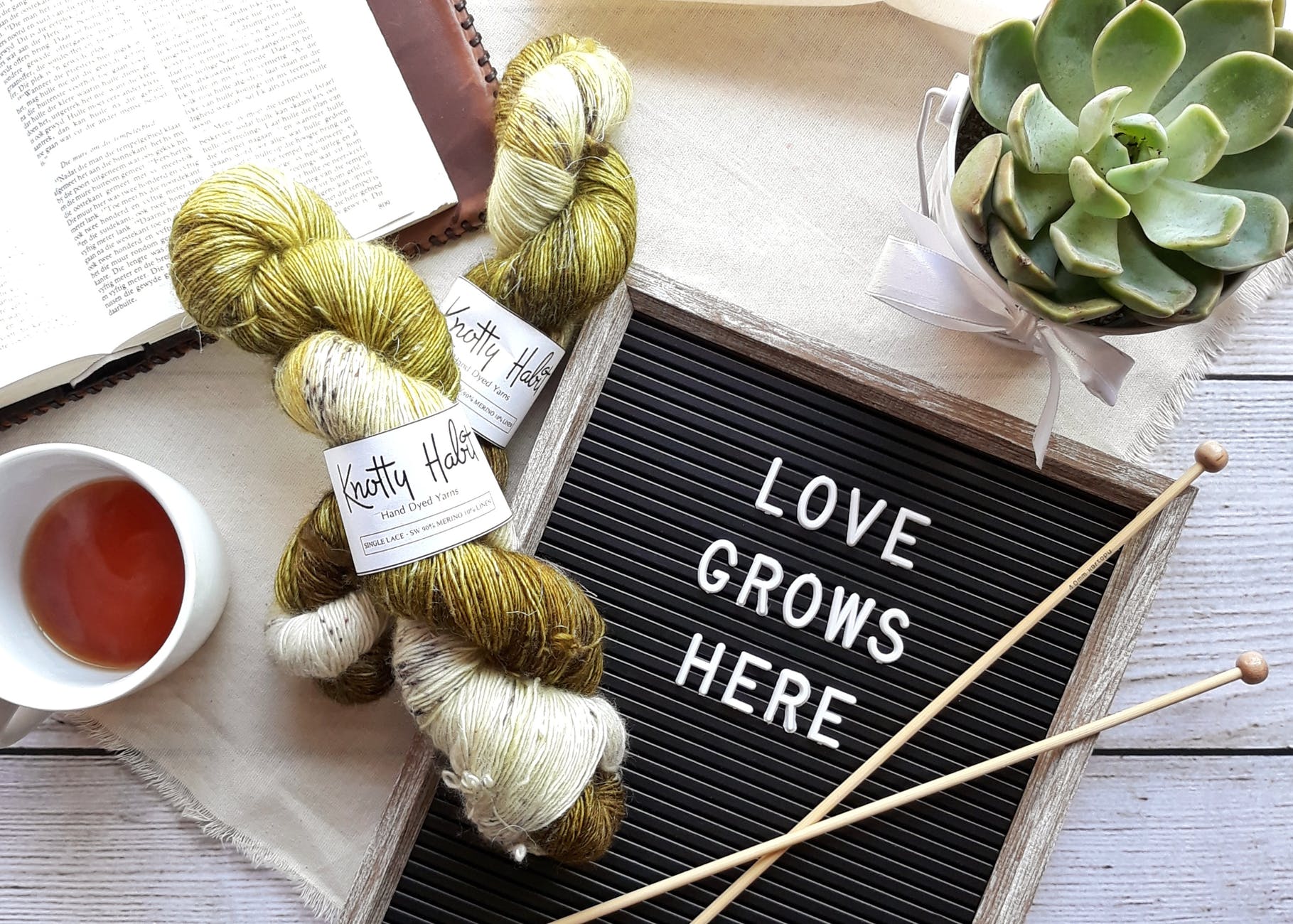 white ceramic mug beside book
