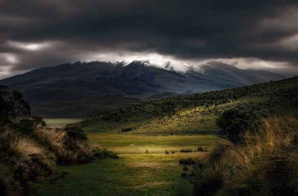photography of mountains under cloudy sky