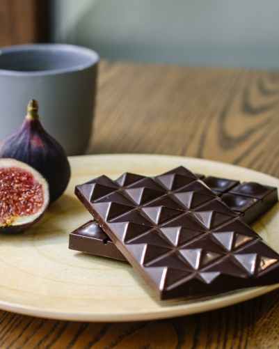 two chocolate bars on top of brown wooden table