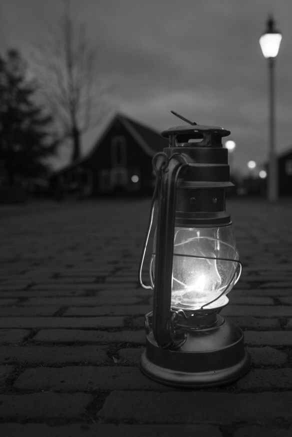 greyscale photography of lamp on floor