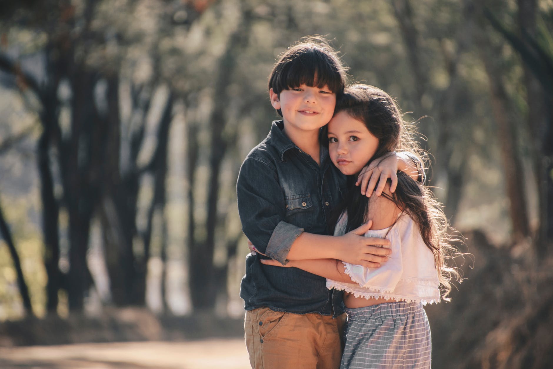 girl and boy standing and hugging