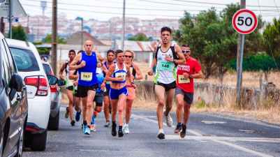 photo of people running beside parked vehicles