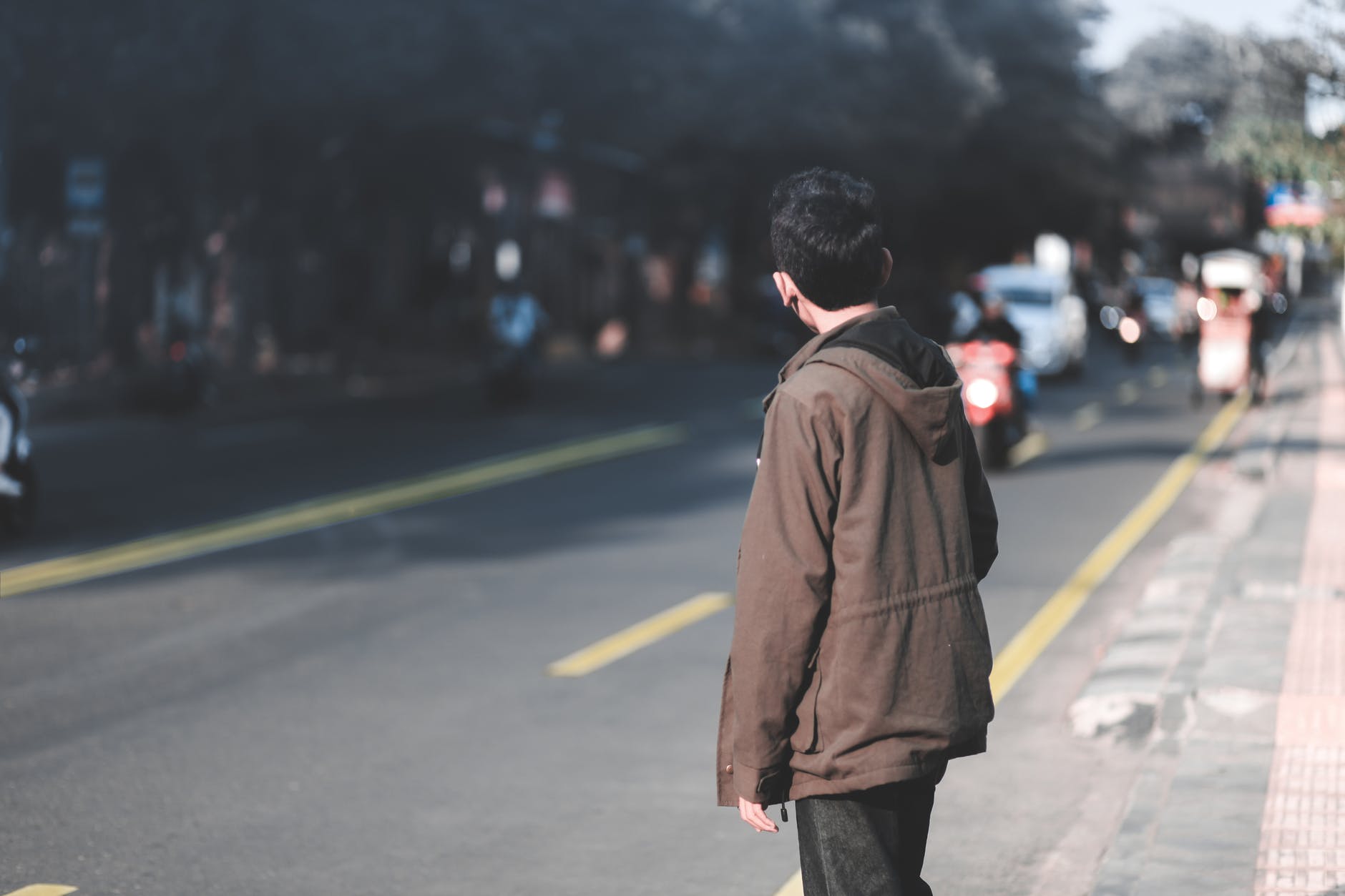 boy facing right side of the road