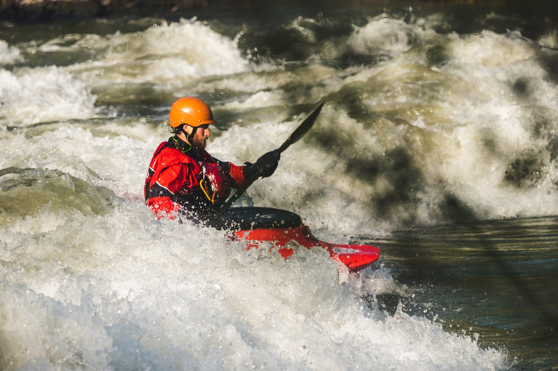 man on red watercraft