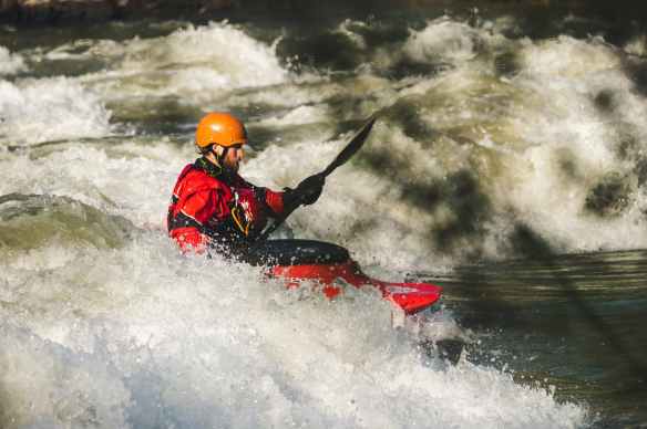 man on red watercraft