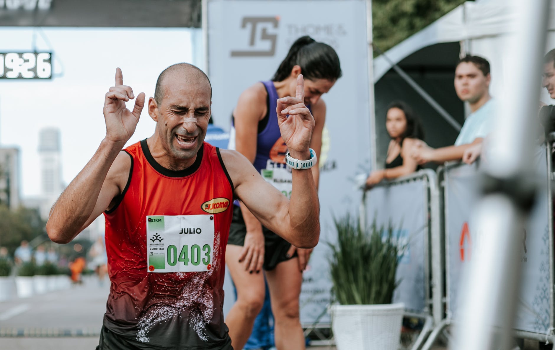 man in red tank top winning a marathon
