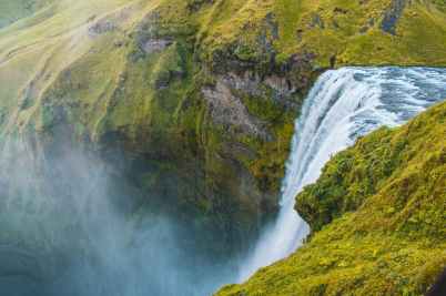 bird s eye view photography of water falls rushing through cliff
