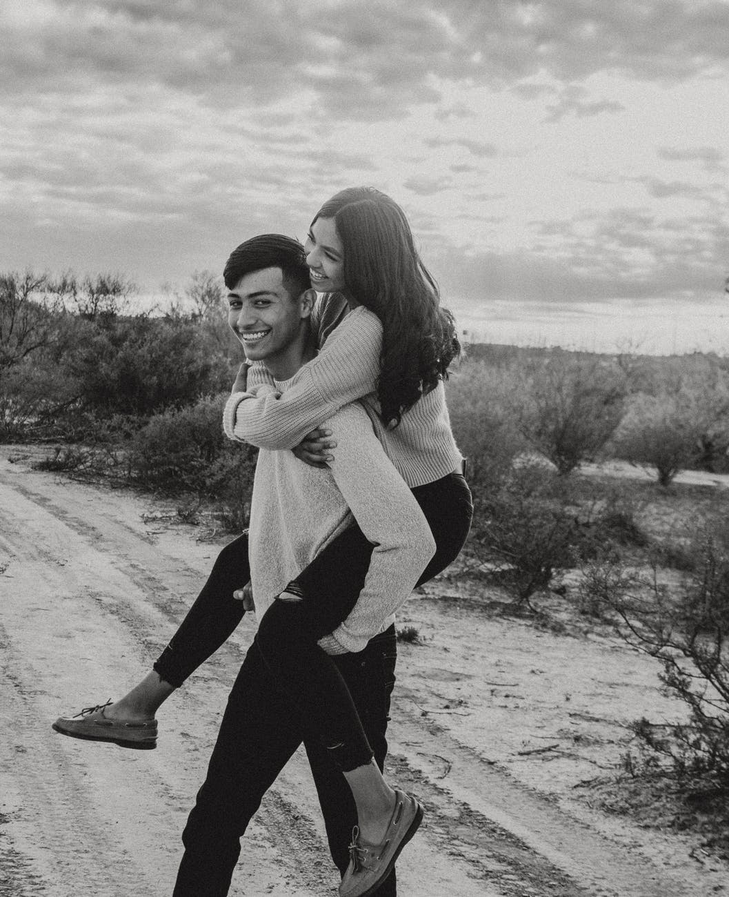 photo of woman riding on man s back