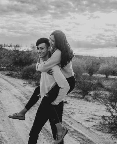 photo of woman riding on man s back