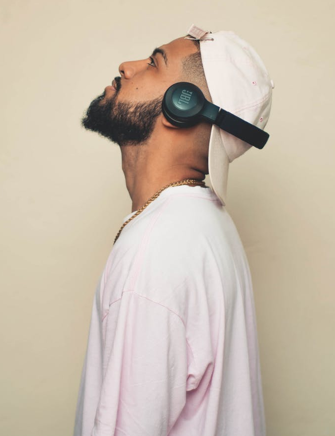 photo of man listening with jbl wireless headset