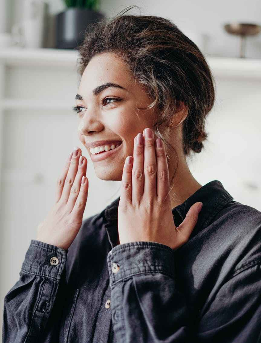 smiling woman in black denim long sleeve