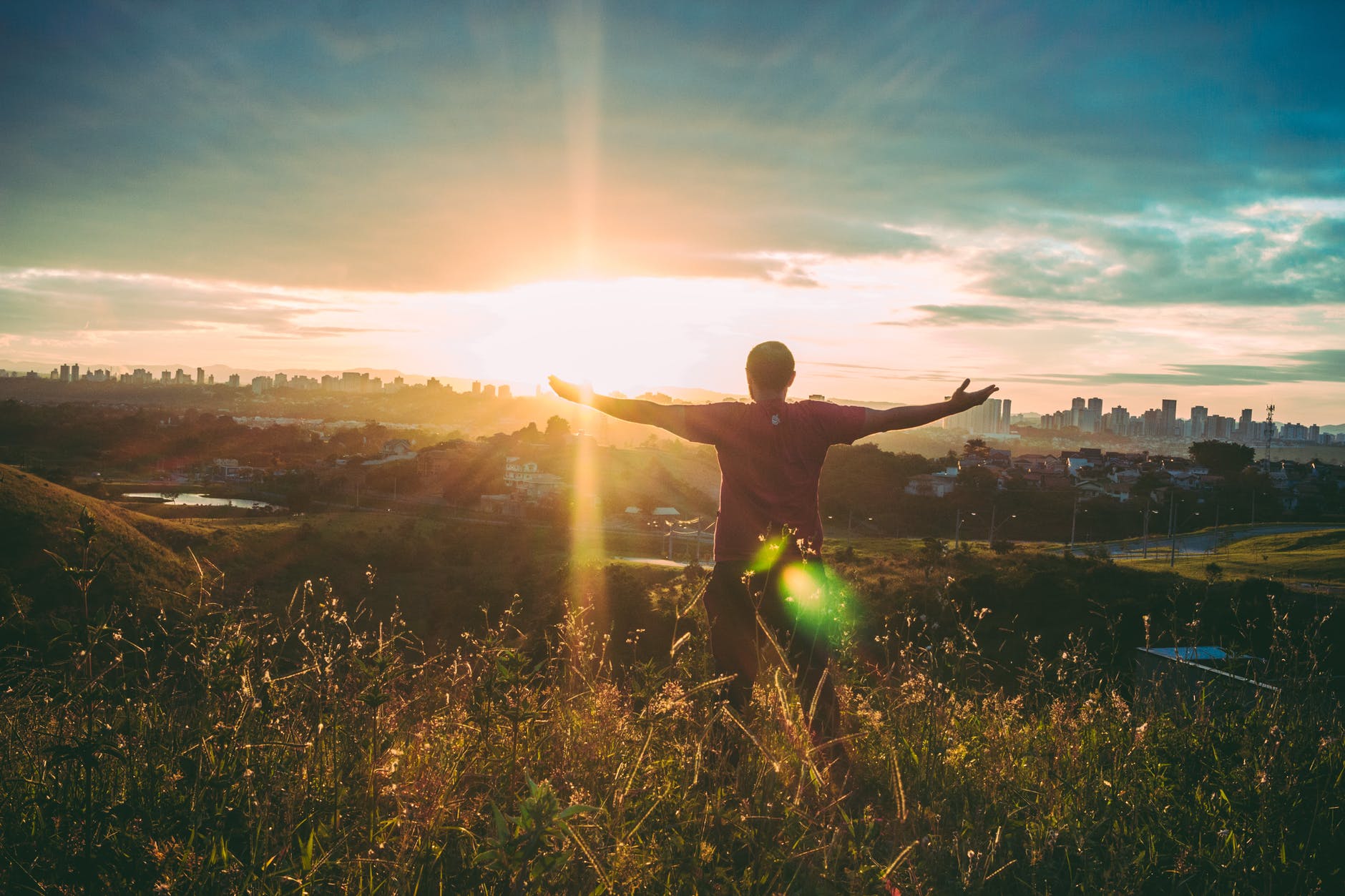 person spreading hands against sun