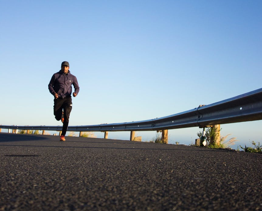 photo of man running during daytime