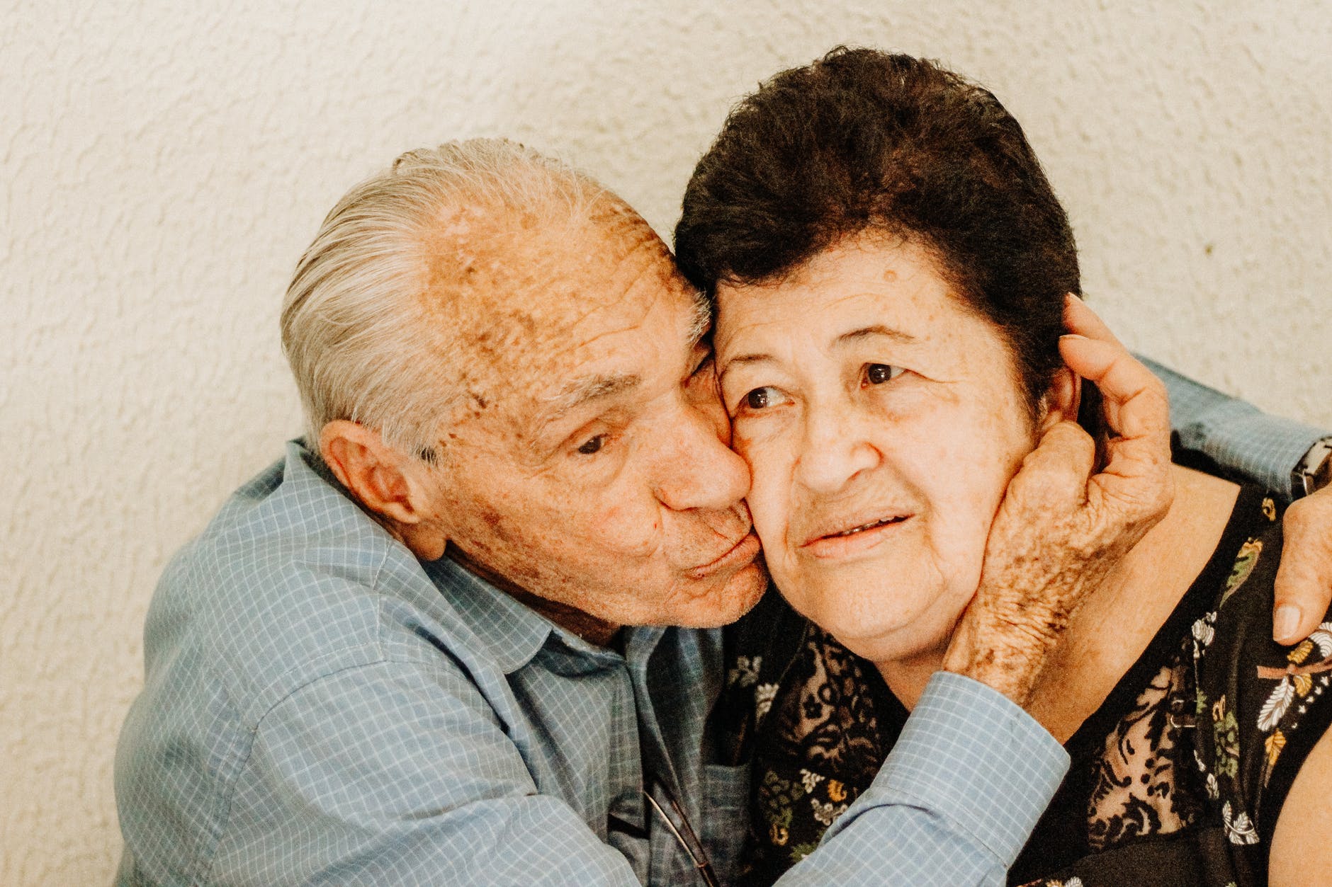 man kissing woman s cheek