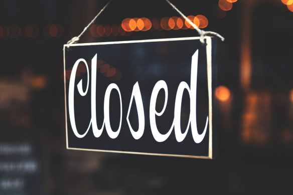 selective focus photography of closed signage
