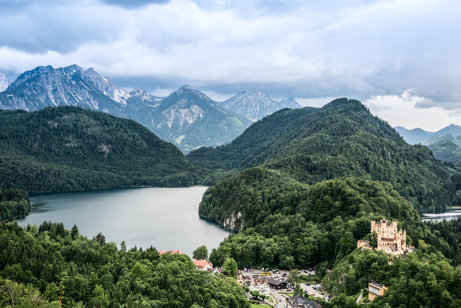 green mountains near river under blue sky