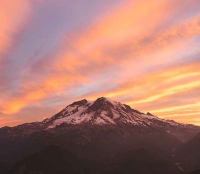 photo of mountain under orange sky